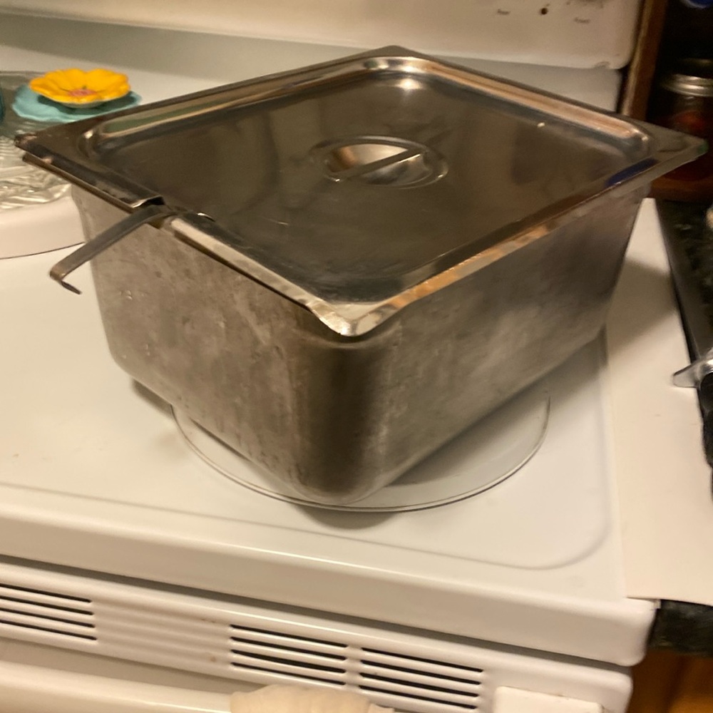 Stainless steel Vollrath food pan with a lid, likely used in commercial food